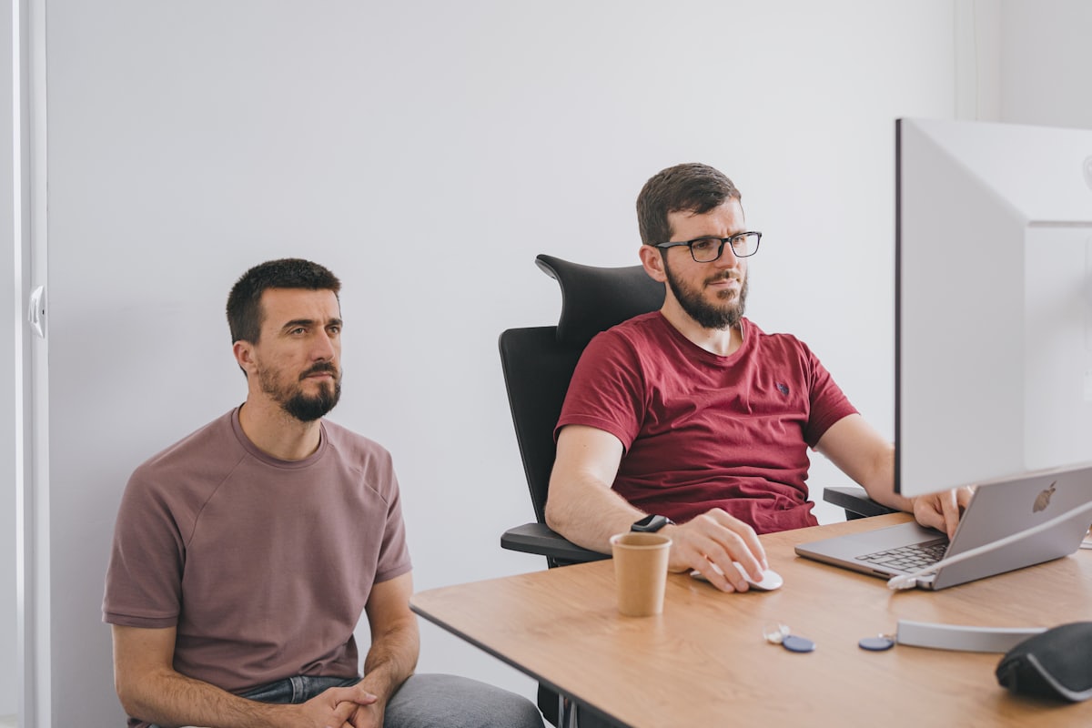 Two colleagues collaborating at a workstation
